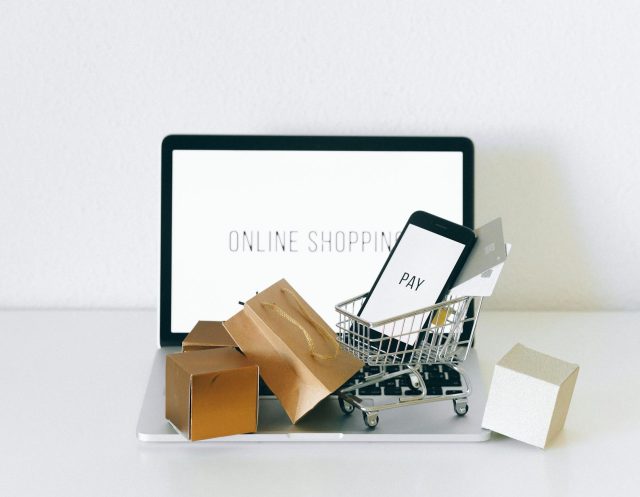a miniature shopping cart on macbook laptop